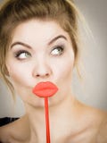 Funny woman holding big red lips on stick stock photography Funny woman holding big red lips on stick stock photography