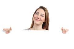 Funny woman presenting and holding a blank sign stock photo Funny woman presenting and holding a blank sign stock photo