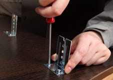 Furniture assembly, installation brackets slide rails with a han royalty free stock images Furniture assembly, installation brackets slide rails with a han royalty free stock images