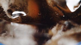 Fyllnads- röd läsk in till exponeringsglas med is på svart bakgrund stock video Fyllnads- röd läsk in till exponeringsglas med is på svart bakgrund stock video
