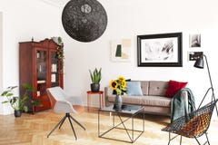 Gallery of pictures on a white wall above a cozy couch with colorful pillows in a stylish living room interior with herringbone pa royalty free stock image Gallery of pictures on a white wall above a cozy couch with colorful pillows in a stylish living room interior with herringbone pa royalty free stock image