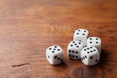 Game of chance concept. Gambling devices. White dice on rustic wooden board. Copy space for text. stock images Game of chance concept. Gambling devices. White dice on rustic wooden board. Copy space for text. stock images