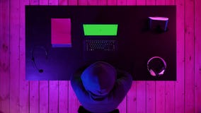 Gamer or streamer watching a game on the screen of laptop. Green Screen Mock-up Display. stock footage Gamer or streamer watching a game on the screen of laptop. Green Screen Mock-up Display. stock footage