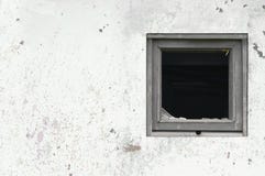 Gammal åldrig rostad för hyddakoja för grå vit målarfärg för vägg, bruten träram för fönsterexponeringsglas, målad riden ut smuts royaltyfri fotografi Gammal åldrig rostad för hyddakoja för grå vit målarfärg för vägg, bruten träram för fönsterexponeringsglas, målad riden ut smuts royaltyfri fotografi