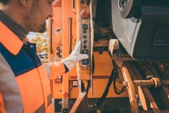 Worker emptying dustbin into waste vehicle Stock Photos Worker emptying dustbin into waste vehicle Stock Photos