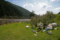 Garbage on the river bank in the mountains royalty free stock photography Garbage on the river bank in the mountains royalty free stock photography