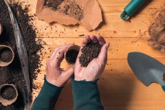 Gardener filling biodegradable soil pot container royalty free stock images Gardener filling biodegradable soil pot container royalty free stock images