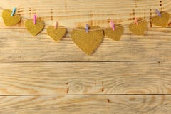 A garland of hearts on clothespins on a natural wooden background. view from above . space for text stock photography A garland of hearts on clothespins on a natural wooden background. view from above . space for text stock photography