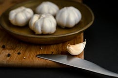 Garlic and black pepper on a wooden dashboard royalty free stock photography Garlic and black pepper on a wooden dashboard royalty free stock photography