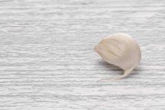 Garlic segment on a white wooden table royalty free stock photo Garlic segment on a white wooden table royalty free stock photo