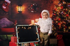 Garçon habillé en Noël de Père Noël photographie stock Garçon habillé en Noël de Père Noël photographie stock
