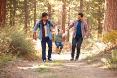 Gay Male Couple With Daughter Walking Through Fall Woodland stock photos Gay Male Couple With Daughter Walking Through Fall Woodland stock photos