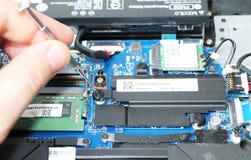 A geek cleans a laptop cooler. Contaminated computer cooling system. stock image A geek cleans a laptop cooler. Contaminated computer cooling system. stock image