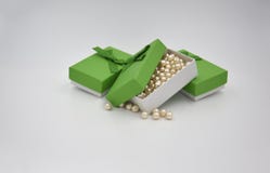 Gelbe goldene Ballperlen des Elfenbeins in der grünen Geschenkbox mit zwei anderen grünen Geschenkboxen mit Bogen stockfotos Gelbe goldene Ballperlen des Elfenbeins in der grünen Geschenkbox mit zwei anderen grünen Geschenkboxen mit Bogen stockfotos