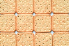 Gele geometrische achtergrond met dozijn gestippelde crackers stock afbeeldingen Gele geometrische achtergrond met dozijn gestippelde crackers stock afbeeldingen