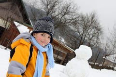 Gelukkig mooi jong geitje met zijn sneeuwman stock fotografie Gelukkig mooi jong geitje met zijn sneeuwman stock fotografie