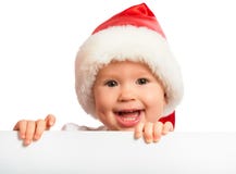 Gelukkige baby in een geïsoleerde Kerstmishoed en een leeg aanplakbord stock fotografie Gelukkige baby in een geïsoleerde Kerstmishoed en een leeg aanplakbord stock fotografie