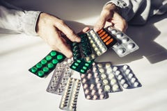 Geneeskundepillen of capsules met oude woman’shanden op witte achtergrond met exemplaarruimte Blaarpak royalty-vrije stock foto's Geneeskundepillen of capsules met oude woman’shanden op witte achtergrond met exemplaarruimte Blaarpak royalty-vrije stock foto's