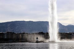 Geneva Water jet deau Water Fountain and mountain Mont Saleve in winter stock images Geneva Water jet deau Water Fountain and mountain Mont Saleve in winter stock images