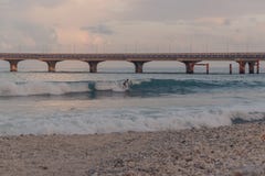 Gente que practica surf en una pequeña playa en varón, Maldivas fotos de archivo libres de regalías Gente que practica surf en una pequeña playa en varón, Maldivas fotos de archivo libres de regalías