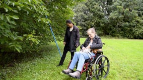 Disabled Female and Asian Friend Picking Walnuts, Caregiver, Carer, Real, Healthcare