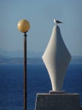 Geometric sculpture with lamppost and seagull