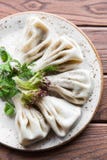 Georgian dumplings Khinkali with meat, greens on a wooden rustic table. Close up royalty free stock photo Georgian dumplings Khinkali with meat, greens on a wooden rustic table. Close up royalty free stock photo