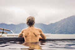 Geothermal Spa. Man Relaxing In Hot Spring Pool. Young Man Enjoying Bathing Relaxed In A Blue Water Lagoon, Tourist Royalty Free Stock Photo