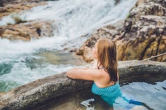 Geothermal Spa. Woman Relaxing In Hot Spring Pool Against The Background Of A Waterfall Royalty Free Stock Photos