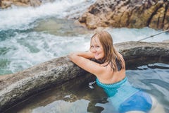 Geothermal Spa. Woman Relaxing In Hot Spring Pool Against The Background Of A Waterfall Stock Photos Geothermal Spa. Woman Relaxing In Hot Spring Pool Against The Background Of A Waterfall Stock Photos
