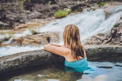 Geothermal Spa. Woman Relaxing In Hot Spring Pool Against The Background Of A Waterfall Royalty Free Stock Photography Geothermal Spa. Woman Relaxing In Hot Spring Pool Against The Background Of A Waterfall Royalty Free Stock Photography