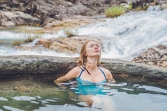 Geothermal Spa. Woman Relaxing In Hot Spring Pool Against The Background Of A Waterfall Stock Image