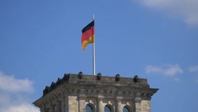 Germany Flag Fluttering Upon The Reichstag Building in Berlin, Germany