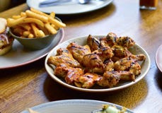 Geroosterd Kippenvleugels & Chips Placed bij Restaurant ` s het Dineren Tabl royalty-vrije stock afbeelding Geroosterd Kippenvleugels & Chips Placed bij Restaurant ` s het Dineren Tabl royalty-vrije stock afbeelding