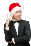 Geschäftsmann, der Santa Claus-Kappenaufmerksamkeitsgesten trägt lizenzfreie stockbilder Geschäftsmann, der Santa Claus-Kappenaufmerksamkeitsgesten trägt lizenzfreie stockbilder
