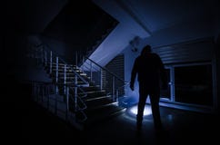 Ghost In Haunted House At Stairs, Mysterious Silhouette Of Ghost Man With Light At Stairs, Horror Scene Of Scary Ghost Spooky Llig Stock Image