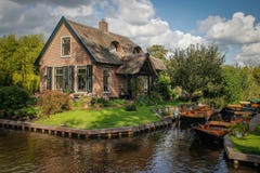 Beautiful fairy village with channels which are floating boats and cozy traditional houses stock photo Beautiful fairy village with channels which are floating boats and cozy traditional houses stock photo