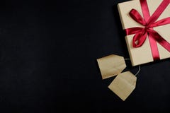 Gift box with two discount labels on black background. Black Friday concept stock photography Gift box with two discount labels on black background. Black Friday concept stock photography