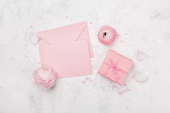 Gift or present box, pink paper blank and ranunculus flower on white table from above for wedding mockup or greeting card flat lay stock photo Gift or present box, pink paper blank and ranunculus flower on white table from above for wedding mockup or greeting card flat lay stock photo
