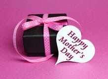 Gift With Pink Polka Dot Ribbon And White Heart Shape Gift Tag With Happy Mothers Day Royalty Free Stock Images