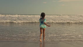 Gimbal tracking sequence of 8 or 9 years old beautiful and happy Asian Indonesian child girl running carefree on the beach stock footage Gimbal tracking sequence of 8 or 9 years old beautiful and happy Asian Indonesian child girl running carefree on the beach stock footage