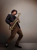 Giovane musicista che gioca sul sassofono fotografia stock libera da diritti Giovane musicista che gioca sul sassofono fotografia stock libera da diritti