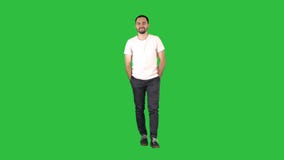 Giovane uomo adulto sicuro che cammina in avanti e che esamina macchina fotografica in camicia bianca su uno schermo verde, chiav video d archivio Giovane uomo adulto sicuro che cammina in avanti e che esamina macchina fotografica in camicia bianca su uno schermo verde, chiav video d archivio