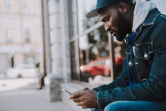 Giovane uomo afroamericano disturbato che legge un messaggio immagini stock libere da diritti Giovane uomo afroamericano disturbato che legge un messaggio immagini stock libere da diritti