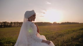 Girl in a beautiful white national dress is a beautiful meadow in the evening sun. Beautiful young girl. stock video Girl in a beautiful white national dress is a beautiful meadow in the evening sun. Beautiful young girl. stock video
