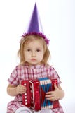 Girl with birthday cap playing accordion stock images Girl with birthday cap playing accordion stock images