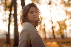 Girl with brown hair in the autumn forest on the backlight royalty free stock images Girl with brown hair in the autumn forest on the backlight royalty free stock images