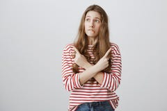 Girl is confused in making choices. Portrait of nervous doubtful female student crossing hands and pointing in different royalty free stock photos Girl is confused in making choices. Portrait of nervous doubtful female student crossing hands and pointing in different royalty free stock photos