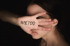 Girl covers her face with hand with hashtag metoo against harassment