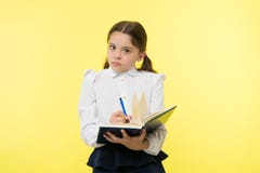 Girl cute schoolgirl in uniform hold book with information yellow background. Pupil get information from book. Child royalty free stock images Girl cute schoolgirl in uniform hold book with information yellow background. Pupil get information from book. Child royalty free stock images